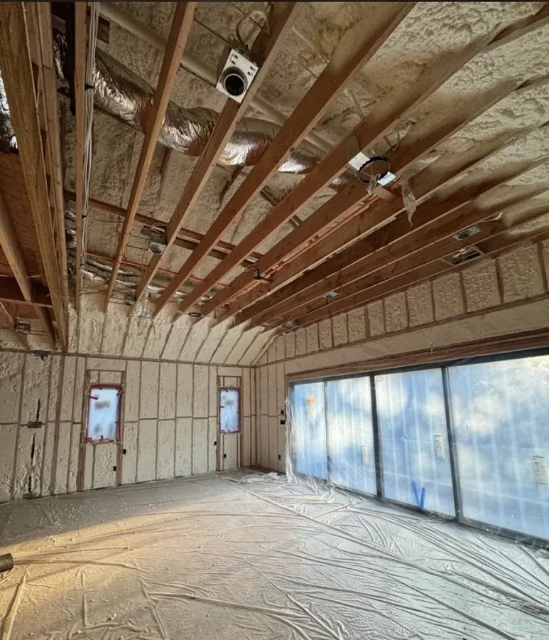 Interior walls and ceiling insulated with spray foam during new construction in Milford